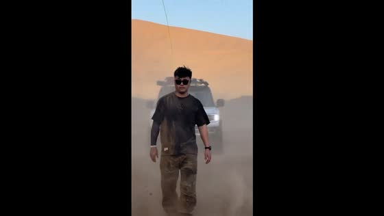 Man covered in dust after Ford F-150 speeds by in Shaanxi, China 