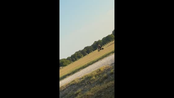 Woman falls off dirt bike on grassy slope in Seagoville, Texas, USA