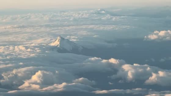 Aerial sunset view of snow-capped Mount Hood from flight in Portland, Oregon, USA