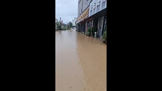 Murky floodwaters cover urban street in Jiangsu, China
