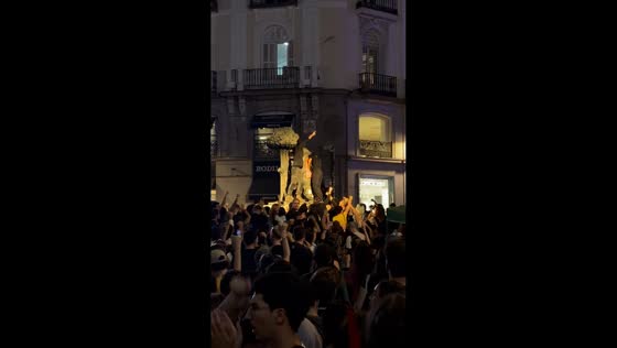 Demonstrators gather around monument during housing protest in Madrid, Spain