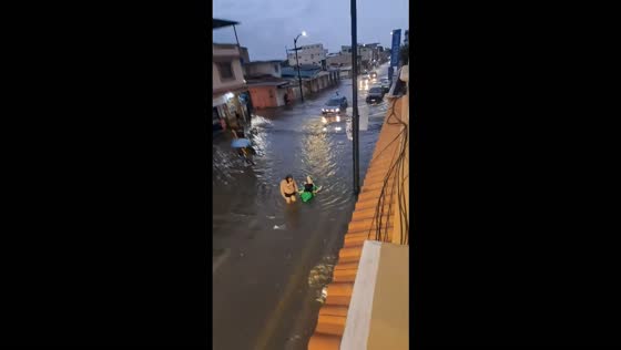 Flooding submerges streets and vehicles as residents navigate waist-deep water in Guayaquil, Ecuador