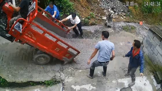 Cement spills during uphill tricycle push in Guizhou, China