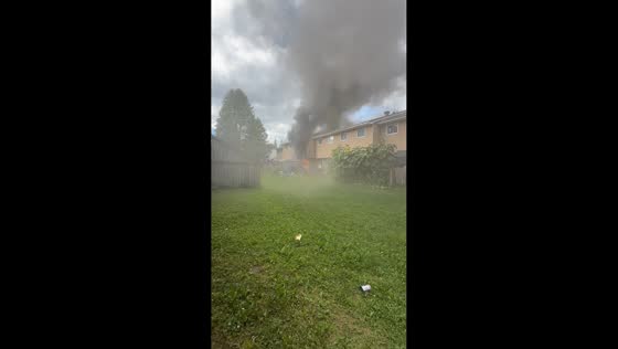 Massive fire sends flames and thick smoke over townhouses in North Bay, Canada