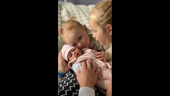 Sisters meet their newborn sibling for the first time in Saint-Herblain, France
