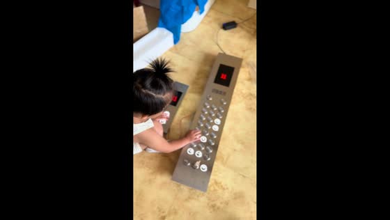 Toddler plays with simulated elevator toy in Liaoning, China