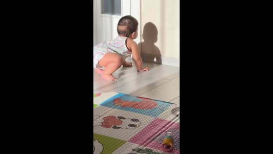 Curious baby mesmerized by shadow in Izmir, Turkey