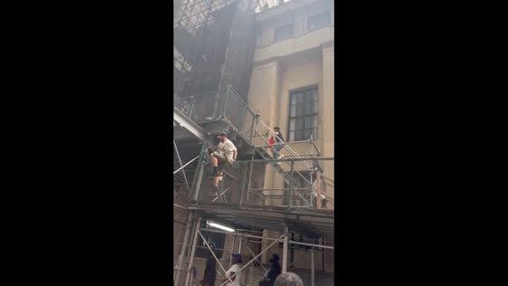 Fans climb scaffolding during Knicks championship celebration in Manhattan, New York, USA