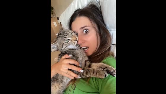 The playful owner teased her cat by biting her!
