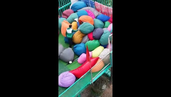 Woman slides into bean bags on inflatable tube in Sapa Green Valley, Vietnam