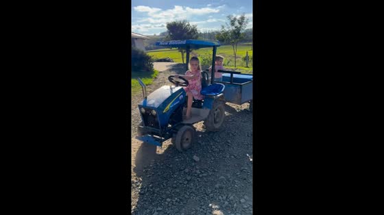 Young girl skillfully drives tractor in Taió, Brazil