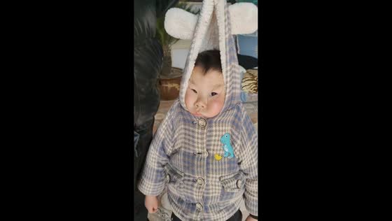 Man uses manual scale to determine boy's weight in Henan, China