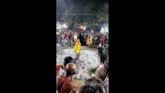 Women run across hot coals during temple festival in Kadayanallur, India