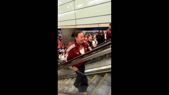 Woman reaches the top after falling on downward escalator in London, UK