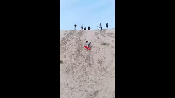 Woman tumbles while sand sledding in Tianjin, China