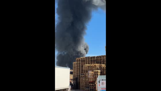Heavy black smoke rises from factory fire in Trafford Park, Manchester, UK