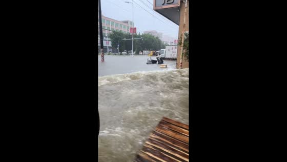 Bus drives through flooded road in Guangdong, China