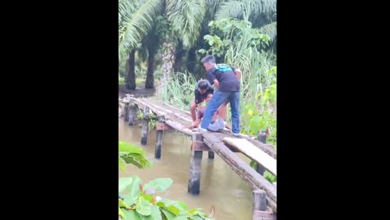 Birthday prank backfires as man falls off bridge first in Tana, Indonesia