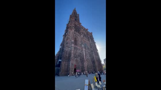 Strasbourg Cathedral stands tall in afternoon sunlight in Strasbourg, France