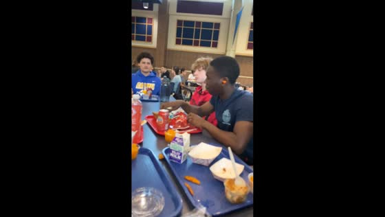 Snack lands in friend's ear during playful toss in Carmel, Indiana, USA
