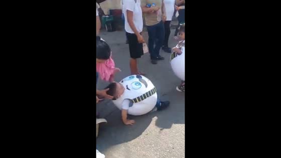 Child in egg costume stumbles during local parade in Acayucan, Mexico