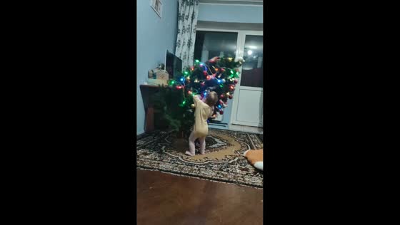 Toddler tips Christmas tree while playing in Ivano-Frankivsk, Ukraine