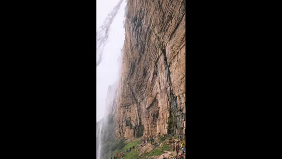 Visitors gather to witness the breathtaking Laolongkou Waterfall in Hubei, China