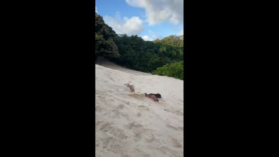 Little girl trips while chasing boy on the beach in Castanhal, Brazil