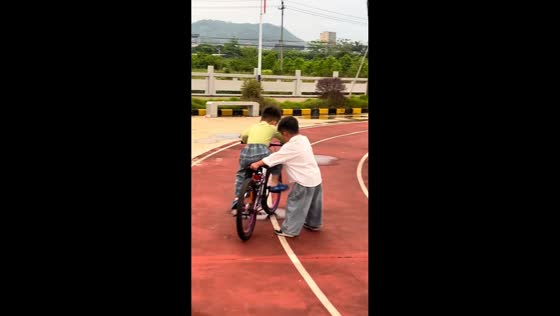 Children fall while learning to ride bicycle in Guangdong, China