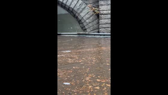 Vehicles navigate flood on West Side Highway in New York, USA