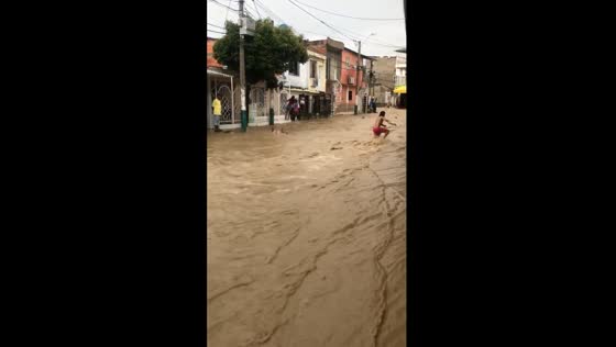 Cartagena's streets turn into rivers as locals playfully ride the floodwaters