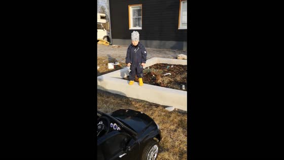 Boy falls off retaining wall while laughing at a toy car in Ylivieska, Finland