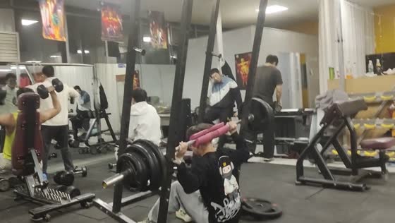 College student narrowly escapes mishap in gym: barbell squat fail caught on camera