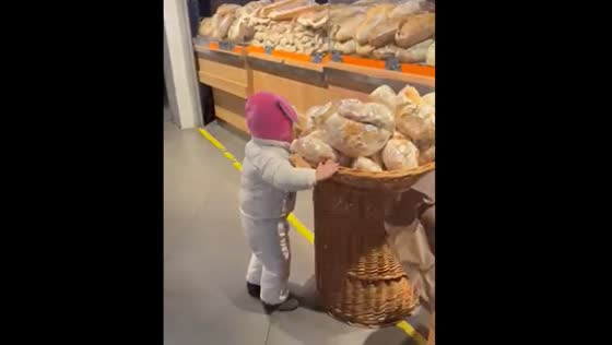 Child tries to bite food in Ukrainian store