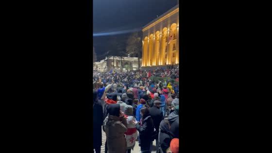 Protesters rally with flashlights and chant in unison in Tbilisi, Georgia