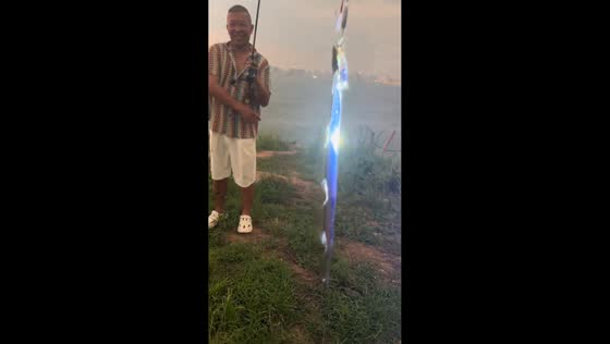Man showcases cutlassfish glowing under flashlight in Hainan, China