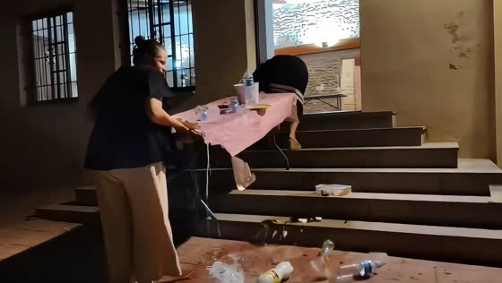 Fully set table spills on staircase during move in La Vall d'Alba, Spain