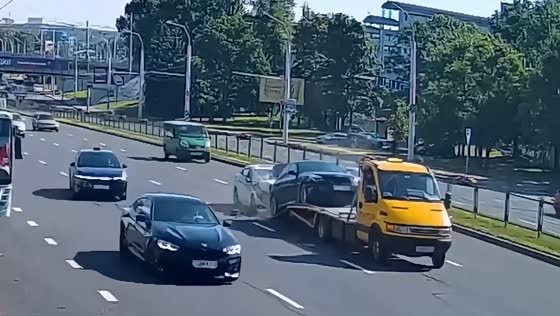 Hyundai pushes broken BMW onto tow truck in Minsk, Belarus