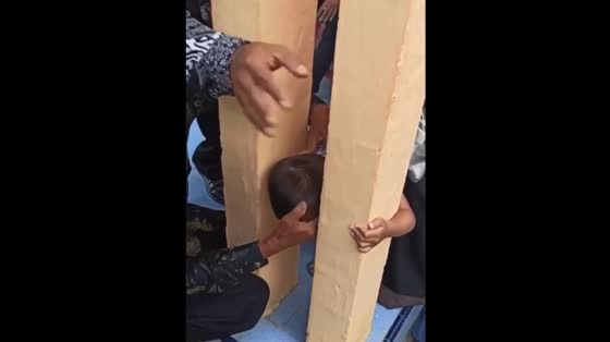 A child was safely rescued after his head was trapped between walls in Indonesia