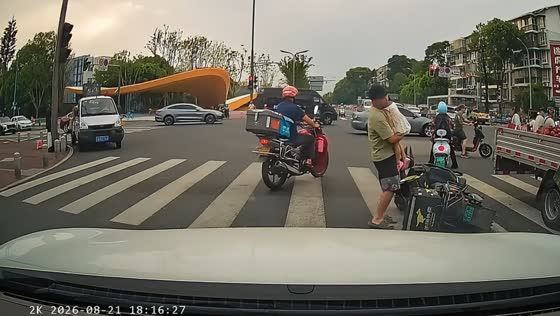 Delivery rider struggles to steady e-scooter while carrying sleeping child in Sichuan, China
