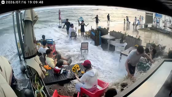 Large wave floods beachfront restaurant patio in Guangxi, China
