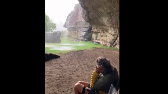 Sheltering under a rock during a rainstorm at Balloch’s Cottages campsite