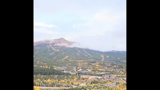 Autumn colors and snow-covered peaks create scenic mountain view in Breckenridge, USA