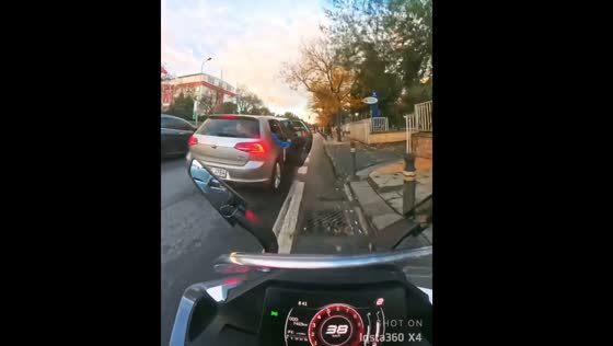 Motorbike rider falls after car door opens unexpectedly in İstanbul
