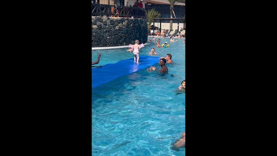 Child runs across water in pool activity