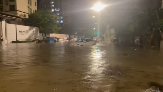 Murky floodwaters cover urban street as vehicles become submerged in Jiangsu, China