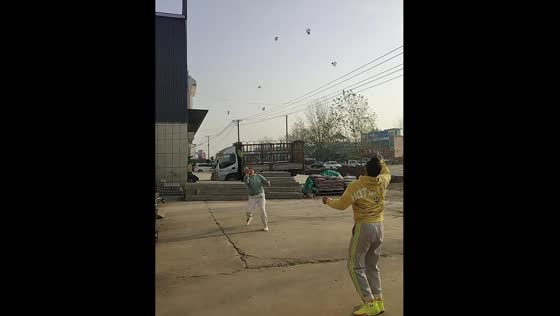 Two men play badminton with six shuttlecocks in Henan Province, China