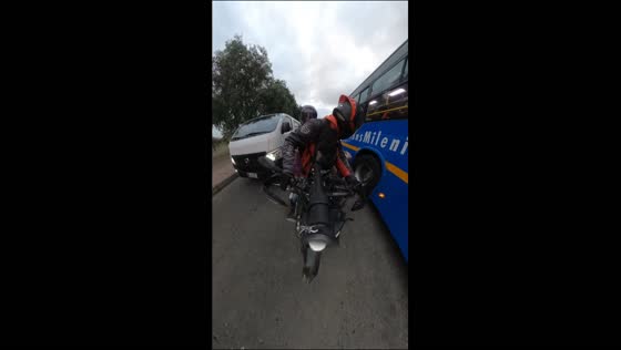Cyclist falls after colliding with a motorcycle amid traffic in Bogotá, Colombia