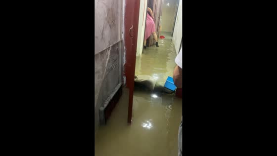 Women struggle with indoor flooding in Shanghai, China