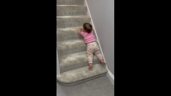 Child finds unique method for stairway descent in London